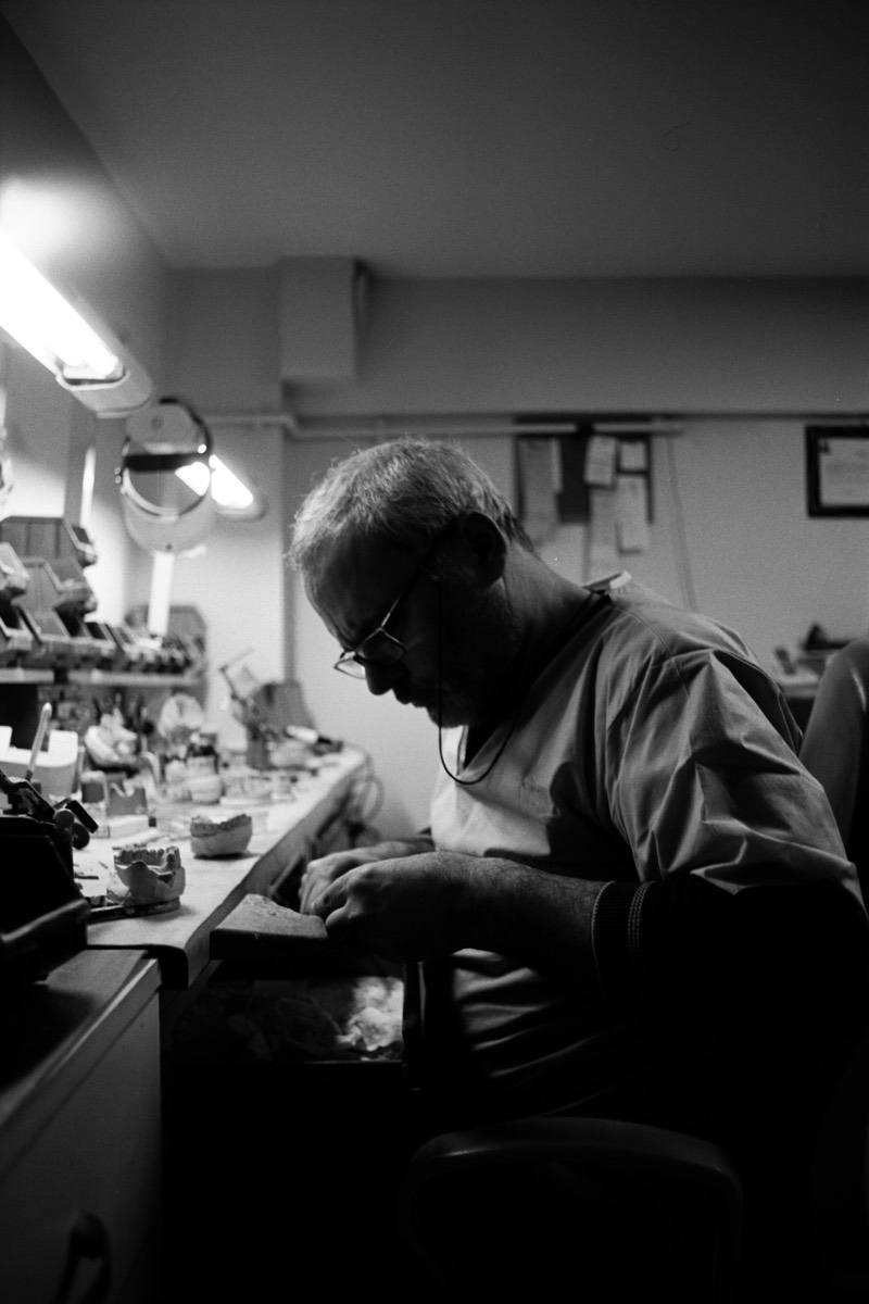 An Adair Dental technician characterizing a case at the bench